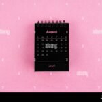 black calendar for august 2027 year on pink background 3ET6F4B